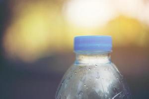 Water bottle with blurred nature background and copy space photo