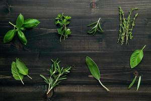 Fresh herbs on dark wood photo