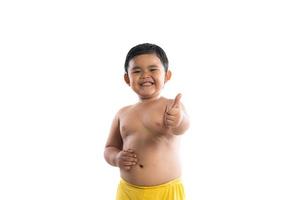 Little boy poses with thumbs up on white background photo