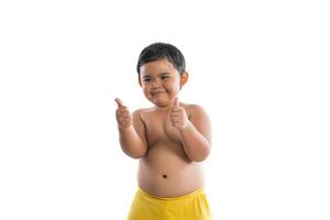 Little boy poses with thumbs up on white background photo