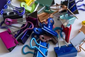 Vibrant colorful binder clips piled up photo