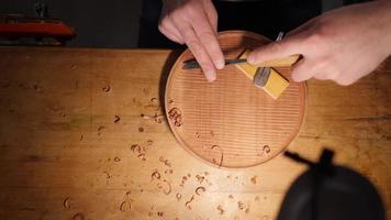 Wood carver cuts mahogany tray with a chisel. Contains sound ASMR video