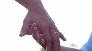 Close up of mother holding a hand of her daughter video