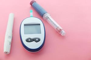 Close-up of diabetic measurement tools and pills on color background photo