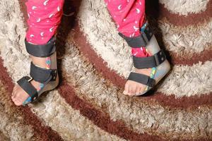Child with cerebral palsy disability, leg orthosis photo