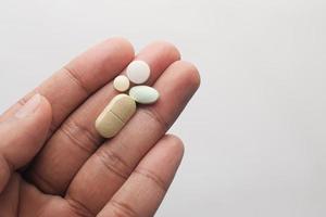 Close-up of man's hand holding pills with copy space photo