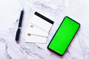 Smartphone, credit cards on tiles background photo