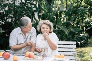 Elderly couple cooking healthy food together photo