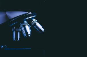 Close-up of microscope lenses on blackground photo