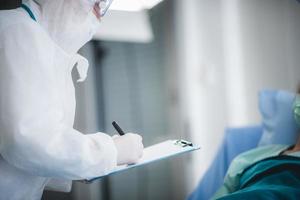 Doctor with clipboard and pen next to patient photo