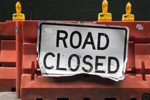 Road Closed sign on a construction barrier photo
