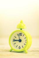 Alarm clock on wooden desk photo