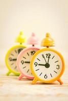 Alarm clocks on a wooden desk photo