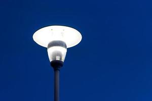 Street lamp against the dark blue sky photo