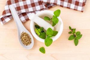 Fresh oregano in a mortar photo