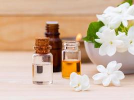 Aroma oil bottles arranged with jasmine photo