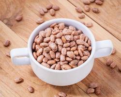 Pinto beans in white bowl photo