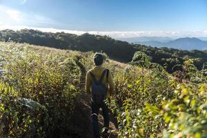 Man walking on the Kew Mae Pan Nature Trail in Thailand photo