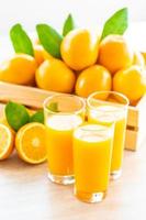 Fresh orange juice and oranges photo