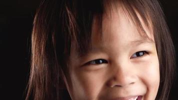 Close-up face portrait of cute little child looking at the camera video