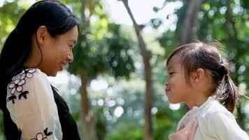 Happy Mother hugging her little daughter smiling on the lawn video