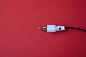 A cable plug connection on a red background photo