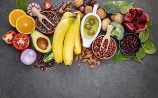 Fruit, veggies, and nuts on a gray background photo