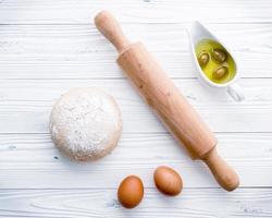 Pizza dough and a rolling pin photo