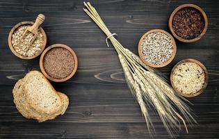 Assorted grains on a dark wooden background photo