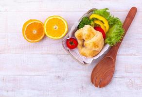 Salad and croissant photo