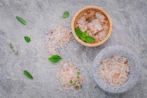 Himalayan pink salt on a gray background photo