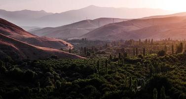 Aerial view of green landscape of green valley, hills, and mountains photo