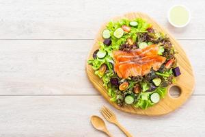 Raw Smoked salmon with fresh green vegetable salad photo