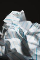 Close-up of crumpled paper on black background photo