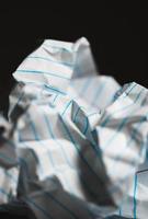 Close-up of crumpled paper on black background photo