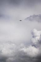 Helicopter flying in clouds photo