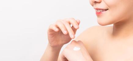 Woman's hand applying moisturizer photo