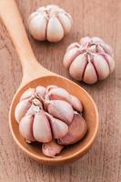 Garlic cloves on wood photo