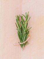 Fresh rosemary on wooden table photo