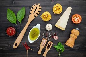 Fresh Italian ingredients on dark wood photo