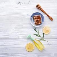 Honey and lemon on white wood photo