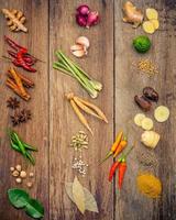 Assorted herbs and spices on wood photo