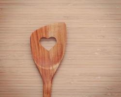 Wooden spoon on a wood background photo