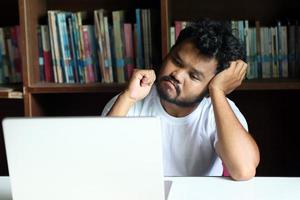 The employee is sitting stressed out with his job photo