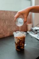 Glass of coffee with milk on the table photo