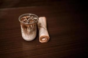 Glass of coffee with milk on the table photo