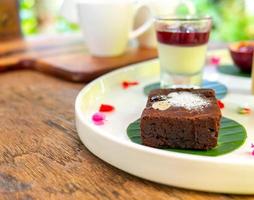 Chocolate brownie topped with almonds photo