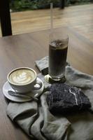 Hot and iced coffee on wooden table photo