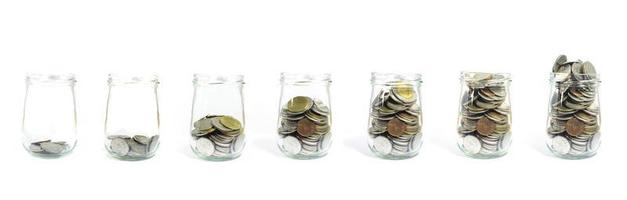 Thai baht in glass jars on white background photo