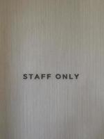 Staff only word on empty wall background photo